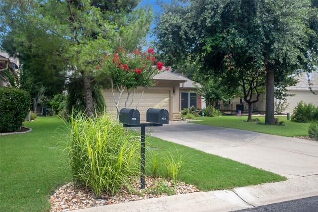 view of front of home with a garage and a front yard