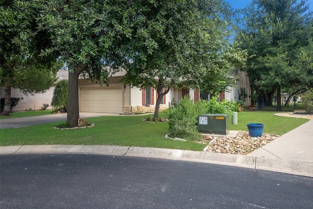 obstructed view of property featuring a garage and a front lawn