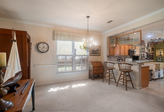 kitchen with backsplash, light colored carpet, crown molding, a kitchen breakfast bar, and a chandelier