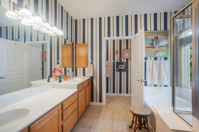 bathroom with tile patterned flooring, a bathing tub, and dual bowl vanity