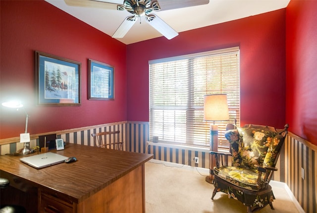 carpeted office space featuring ceiling fan