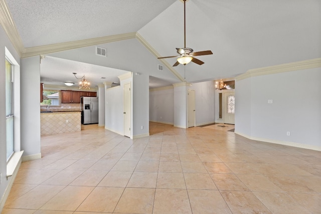 unfurnished living room featuring ornamental molding, vaulted ceiling, light tile patterned floors, a textured ceiling, and ceiling fan with notable chandelier