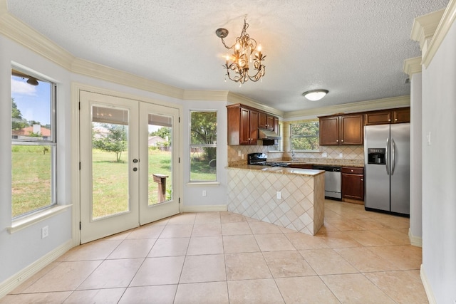 kitchen with french doors, kitchen peninsula, stainless steel appliances, a kitchen bar, and pendant lighting