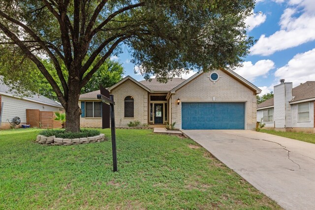 single story home featuring a garage and a front lawn