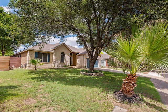 ranch-style home with a front lawn