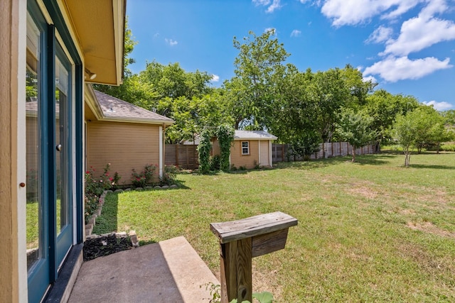 view of yard featuring an outbuilding and a patio area