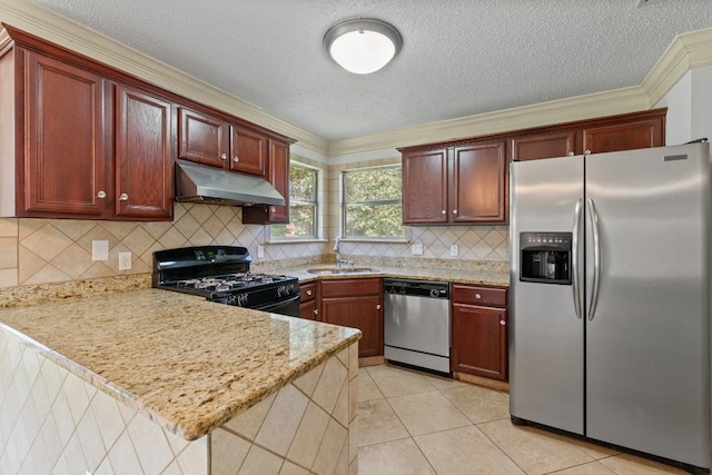 kitchen with appliances with stainless steel finishes, decorative backsplash, light tile patterned flooring, sink, and kitchen peninsula