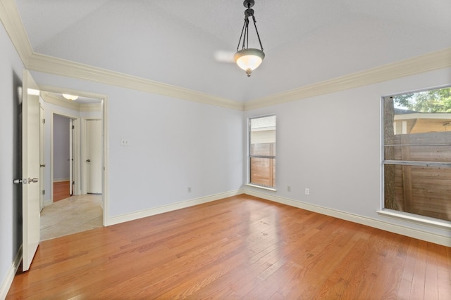 empty room featuring light hardwood / wood-style flooring and crown molding