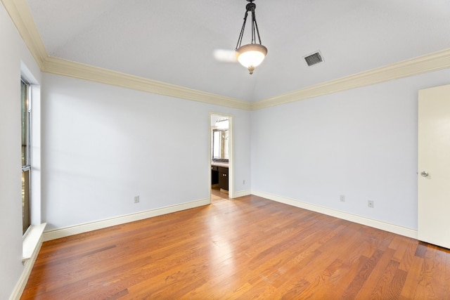 unfurnished room with ornamental molding and wood-type flooring