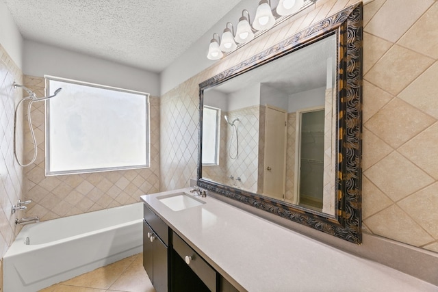 bathroom with tiled shower / bath, vanity, tile patterned flooring, and a textured ceiling