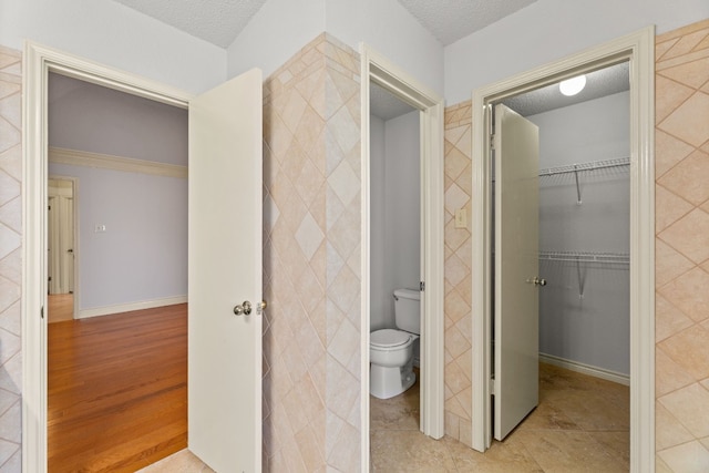 bathroom with a textured ceiling and toilet