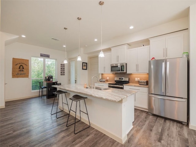 kitchen featuring white cabinets, sink, a kitchen island with sink, and appliances with stainless steel finishes