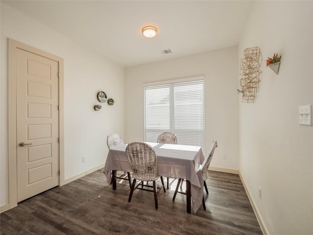 dining area with dark hardwood / wood-style flooring