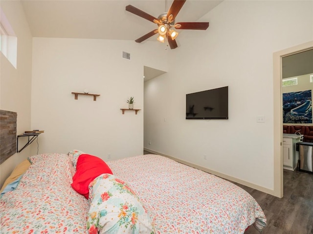 bedroom with ceiling fan, dark hardwood / wood-style flooring, and lofted ceiling