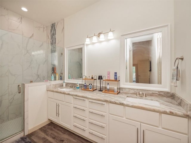 bathroom featuring hardwood / wood-style floors, vanity, and walk in shower