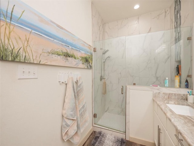 bathroom featuring vanity and a shower with shower door