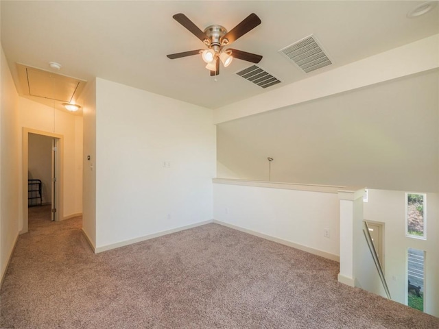 unfurnished room with ceiling fan and light carpet