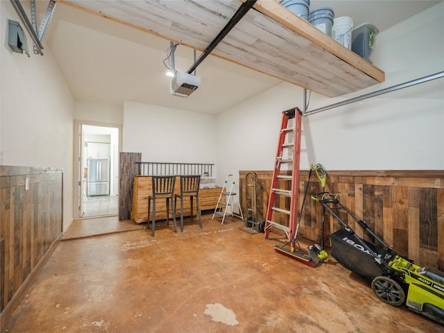 garage featuring wood walls and a garage door opener