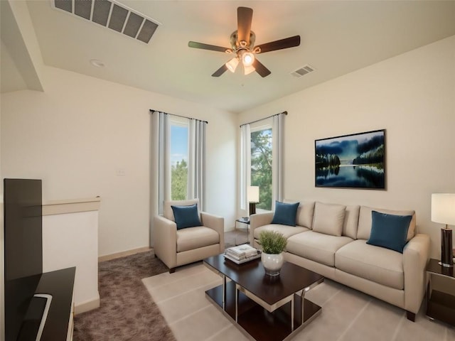 carpeted living room featuring ceiling fan