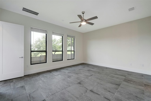 unfurnished room featuring visible vents, baseboards, and a ceiling fan