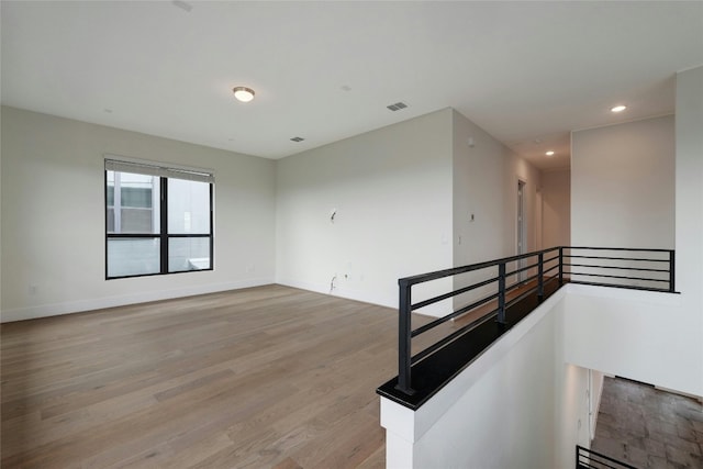 unfurnished room featuring recessed lighting, baseboards, visible vents, and light wood finished floors