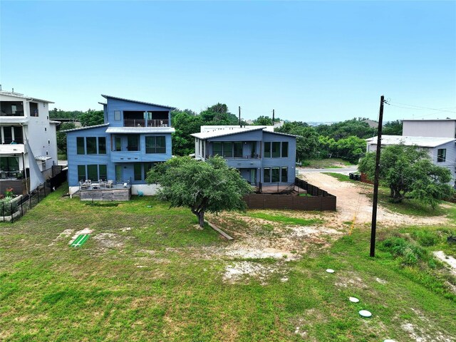 rear view of property featuring a lawn