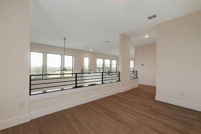 spare room featuring visible vents, recessed lighting, baseboards, and wood finished floors