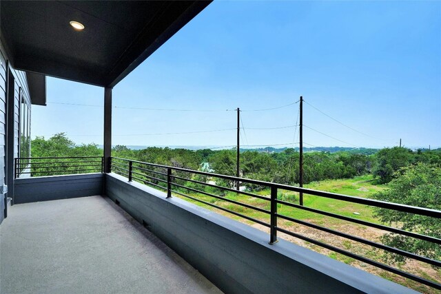 balcony featuring a view of trees