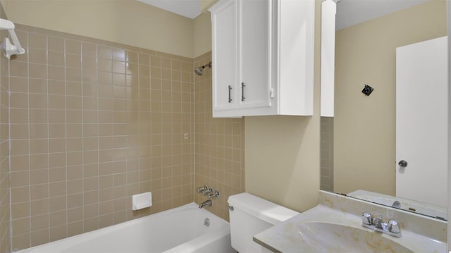 full bathroom featuring vanity, tiled shower / bath combo, and toilet