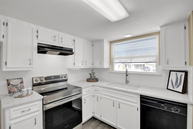 kitchen featuring stainless steel range with electric stovetop, black dishwasher, under cabinet range hood, a sink, and white cabinets