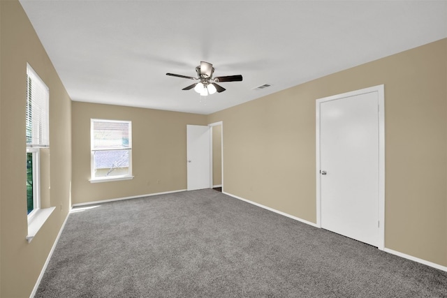 12002 Hardwood Trl, Austin, TX 78750 - unfurnished bedroom featuring carpet flooring, baseboards, and ceiling fan