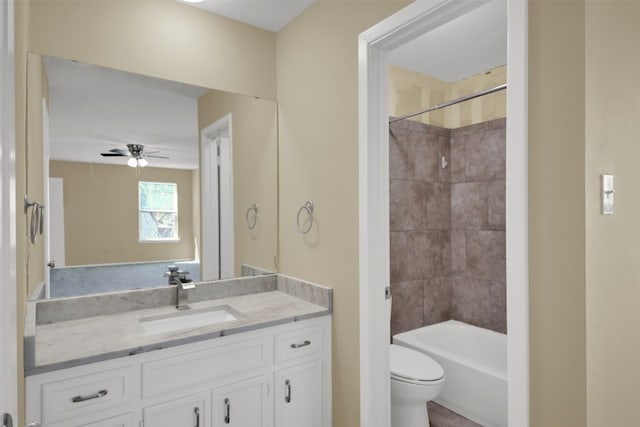 bathroom featuring ceiling fan, toilet, vanity, and  shower combination