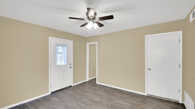 foyer featuring ceiling fan, wood finished floors, and baseboards