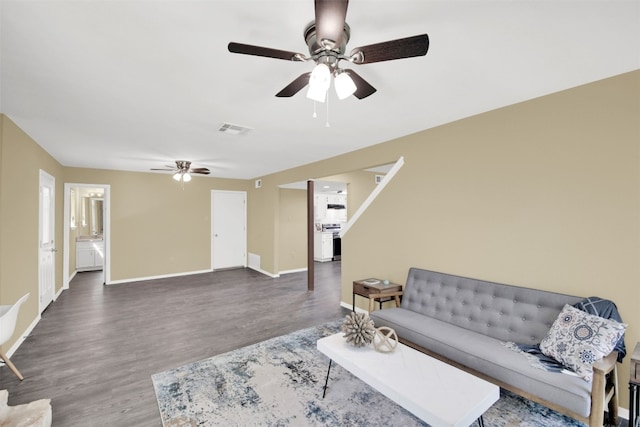 living area with a ceiling fan, wood finished floors, and baseboards