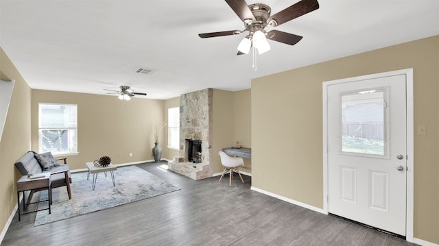 12002 Hardwood Trl, Austin, TX 78750 - living area with ceiling fan, a stone fireplace, wood finished floors, and baseboards