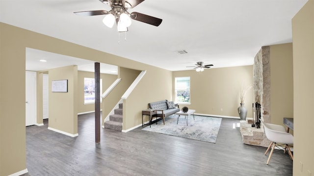 12002 Hardwood Trl, Austin, TX 78750 - living room with ceiling fan, wood finished floors, stairway, and baseboards