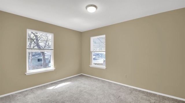 empty room with carpet flooring and baseboards