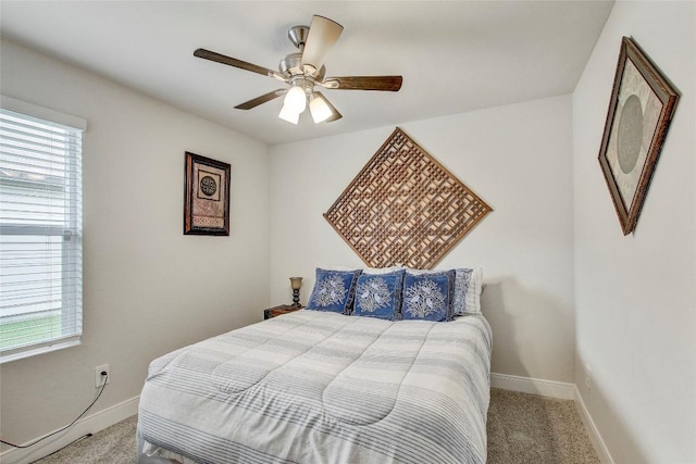 bedroom with ceiling fan, carpet floors, and multiple windows