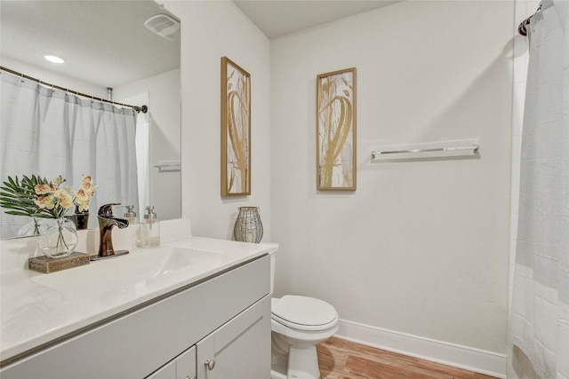 bathroom featuring hardwood / wood-style floors, vanity, toilet, and a shower with shower curtain