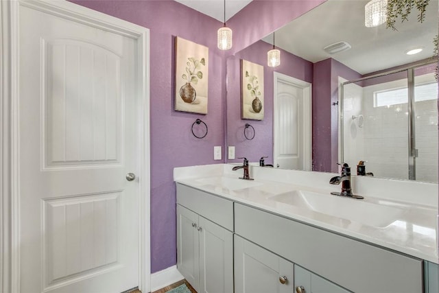 bathroom featuring vanity and a shower with door