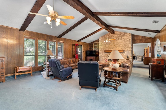 living room featuring vaulted ceiling with beams, wood walls, ceiling fan, and carpet floors