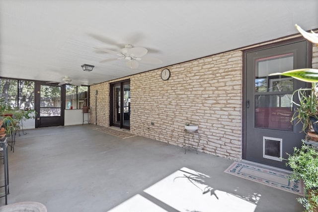 unfurnished sunroom with ceiling fan