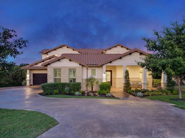 mediterranean / spanish house with a garage