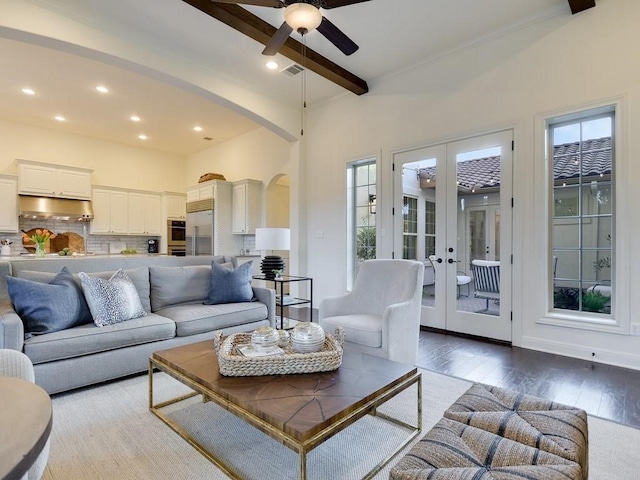 living room with french doors, hardwood / wood-style flooring, ceiling fan, beam ceiling, and a high ceiling