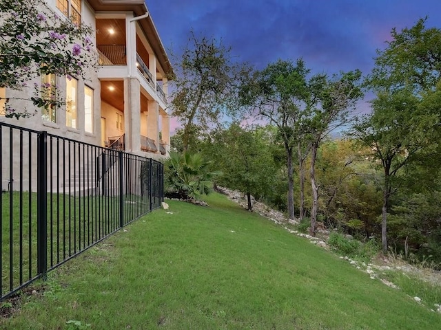 yard at dusk with a balcony