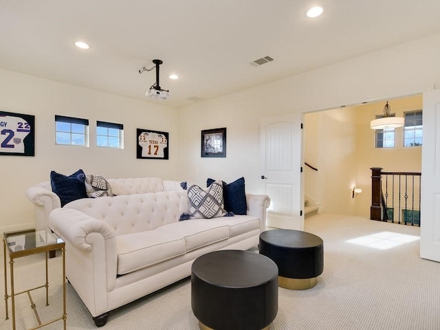 living room featuring a wealth of natural light and light colored carpet