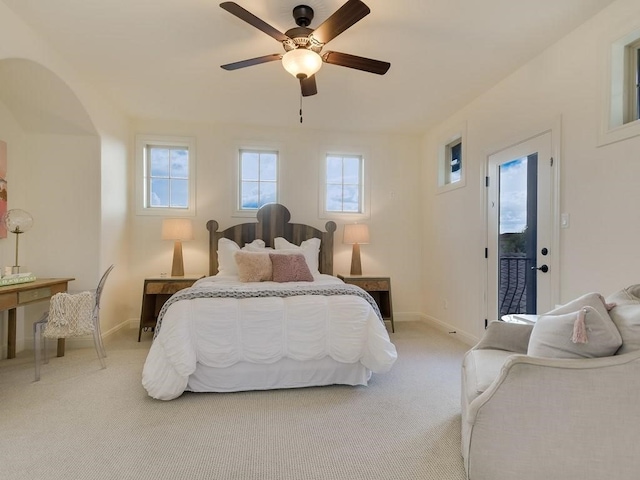 bedroom with light carpet, access to exterior, and ceiling fan