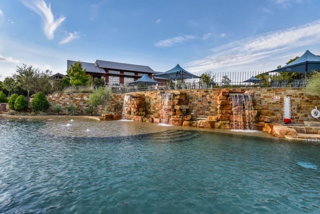 view of pool featuring a water view