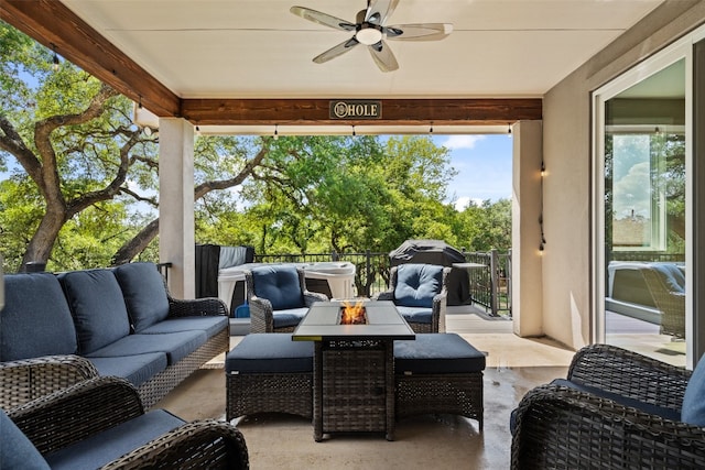 view of patio featuring ceiling fan and an outdoor living space with a fire pit