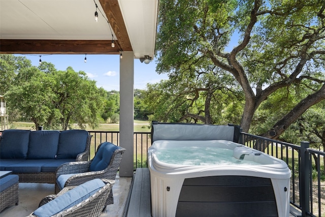 wooden deck with an outdoor hangout area and a hot tub